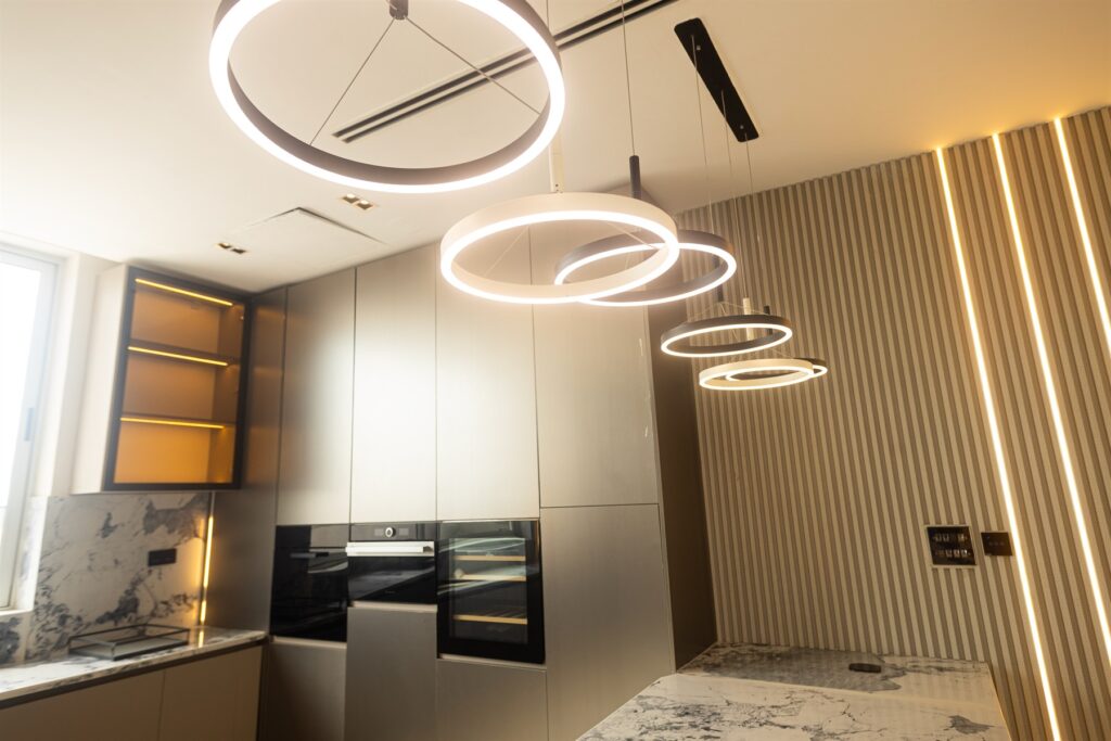 Brum Height 6: Circular pendant lights above the kitchen island